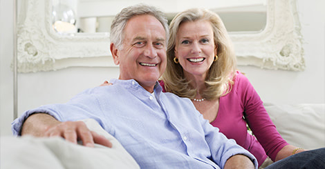 Happy senior couple sitting on the living room photo